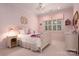 Pink bedroom featuring a canopy bed, chandelier, pink checkered window treatments, and pink butterfly wallpaper at 4225 Jasmin May Dr, Charlotte, NC 28226