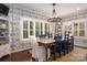 Charming dining room with blue accent wallpaper, chandelier lighting, and beautiful wood table at 4225 Jasmin May Dr, Charlotte, NC 28226