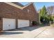 Spacious three car garage and driveway, with basketball hoop and brick exterior at 4225 Jasmin May Dr, Charlotte, NC 28226