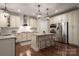 Modern kitchen with stainless steel appliances, a center island, and hardwood floors at 4225 Jasmin May Dr, Charlotte, NC 28226