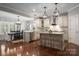 Bright kitchen with white cabinetry, granite countertops, and hardwood floors at 4225 Jasmin May Dr, Charlotte, NC 28226