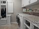 Well-organized laundry room with ample storage, folding counter, and modern appliances at 4225 Jasmin May Dr, Charlotte, NC 28226