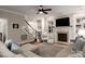 Open-concept living room featuring a fireplace, staircase, and lots of natural light at 4225 Jasmin May Dr, Charlotte, NC 28226