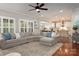 Spacious living room with plush sectional sofa and open view to the kitchen at 4225 Jasmin May Dr, Charlotte, NC 28226
