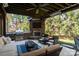 Cozy outdoor living space with stone fireplace, built-in grill, and comfortable seating at 4225 Jasmin May Dr, Charlotte, NC 28226