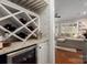 Elegant wine room with custom storage, beverage cooler, and views of the living space at 4225 Jasmin May Dr, Charlotte, NC 28226