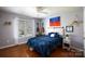 Cozy bedroom with a large window, stylish bedding, hardwood floors and pendant lights at 4232 Belle Meade Cir, Belmont, NC 28012