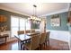 Elegant dining room featuring wood floors, decorative molding, and a stylish light fixture at 4232 Belle Meade Cir, Belmont, NC 28012
