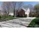 Charming home with a long driveway, brick accents, a covered carport, and well-maintained landscaping at 4232 Belle Meade Cir, Belmont, NC 28012