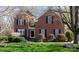 Traditional brick two-story home with black shutters, landscaped front yard, and inviting curb appeal at 4232 Belle Meade Cir, Belmont, NC 28012