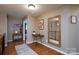 Hallway featuring decorative mirrors and tables, with natural light and hardwood flooring at 4232 Belle Meade Cir, Belmont, NC 28012