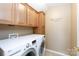 Efficient laundry area with modern washer and dryer, and upper cabinets at 4232 Belle Meade Cir, Belmont, NC 28012