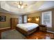 Spacious main bedroom featuring a rustic wooden bed frame, ceiling fan, and natural light at 4232 Belle Meade Cir, Belmont, NC 28012