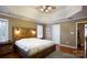 This beautiful bedroom boasts tray ceilings, a rustic bed frame, and natural light from the windows at 4232 Belle Meade Cir, Belmont, NC 28012