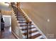 Elegant staircase with wooden steps, decorative iron railings, and neutral wall paint at 4232 Belle Meade Cir, Belmont, NC 28012