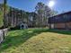 Large, grassy backyard featuring a storage shed and partial fencing offers ample space at 4522 Chuckwood Dr, Mint Hill, NC 28227