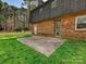 The backyard of this brick house features a small concrete patio and well-maintained lawn at 4522 Chuckwood Dr, Mint Hill, NC 28227