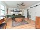Spacious bedroom with modern ceiling fan, natural light, and an adjacent full bathroom at 4522 Chuckwood Dr, Mint Hill, NC 28227