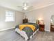 Cozy bedroom with a large window, a ceiling fan, hardwood floors, and traditional decor at 4522 Chuckwood Dr, Mint Hill, NC 28227