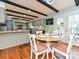 Eat-in kitchen with wooden table and chairs featuring beamed ceilings and access to outdoor patio at 4522 Chuckwood Dr, Mint Hill, NC 28227