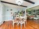 Charming dining room with hardwood floors, decorative lighting and adjacent living area at 4522 Chuckwood Dr, Mint Hill, NC 28227