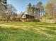 Large grassy backyard with a wooden deck offers outdoor space and entertaining potential at 4522 Chuckwood Dr, Mint Hill, NC 28227