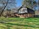 The back of this home has a spacious yard with a patio and a wooden deck at 4522 Chuckwood Dr, Mint Hill, NC 28227