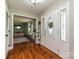 Bright foyer with hardwood floors, a decorative front door, and an open view to the living room at 4522 Chuckwood Dr, Mint Hill, NC 28227
