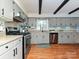 Updated kitchen with gray cabinets, granite countertops, stainless appliances, and hardwood floors at 4522 Chuckwood Dr, Mint Hill, NC 28227