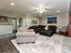 Comfortable living room with a large sectional sofa, an ottoman, and a ceiling fan at 4522 Chuckwood Dr, Mint Hill, NC 28227