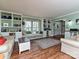 Cozy living room with built-in bookcases, a large window seat, and laminate wood flooring at 4522 Chuckwood Dr, Mint Hill, NC 28227
