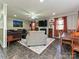 Spacious living room with tile floors, a fireplace, a large sectional, and a ceiling fan at 4522 Chuckwood Dr, Mint Hill, NC 28227