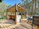 Inviting outdoor deck featuring a wooden pergola and built-in bar for entertaining at 4522 Chuckwood Dr, Mint Hill, NC 28227