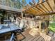 Inviting outdoor deck featuring a wooden pergola, dining area, and built-in bar for entertaining at 4522 Chuckwood Dr, Mint Hill, NC 28227