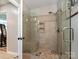Updated tile shower with glass door, built-in bench, and modern fixtures at 4522 Chuckwood Dr, Mint Hill, NC 28227