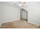 Bright bedroom featuring neutral carpet, ceiling fan with light fixture, and a double door closet at 4818 Grier Farm Ln, Charlotte, NC 28270