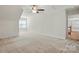 Expansive bedroom featuring neutral carpet, ceiling fan with light fixture, and a window with blinds at 4818 Grier Farm Ln, Charlotte, NC 28270