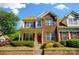 Inviting two-story home with brick facade, red door, and well-maintained landscaping at 4818 Grier Farm Ln, Charlotte, NC 28270