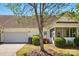 Rear view of a well-maintained home with a garage and screened-in porch at 4818 Grier Farm Ln, Charlotte, NC 28270