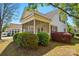 Exterior view of a home's side and rear with a screened porch, landscaping, and red window shutters at 4818 Grier Farm Ln, Charlotte, NC 28270
