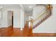 Bright foyer with hardwood floors, staircase, and decorative column at 4818 Grier Farm Ln, Charlotte, NC 28270