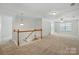 Bright upstairs hallway with carpet, and staircase at 4818 Grier Farm Ln, Charlotte, NC 28270