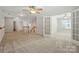 Bright upstairs hallway with carpet, staircase, and a ceiling fan at 4818 Grier Farm Ln, Charlotte, NC 28270