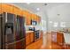 Bright kitchen with wooden floors and cabinets plus stainless steel appliances at 4818 Grier Farm Ln, Charlotte, NC 28270
