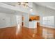Open-concept living area with hardwood floors, high ceilings, and bright kitchen at 4818 Grier Farm Ln, Charlotte, NC 28270