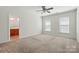 The main bedroom features carpeted floors, neutral walls, and an ensuite bathroom at 4818 Grier Farm Ln, Charlotte, NC 28270
