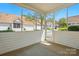 An outdoor patio featuring a screened wall and a view of the front street at 4818 Grier Farm Ln, Charlotte, NC 28270