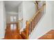 Wooden staircase with white railings and wood floors at 4818 Grier Farm Ln, Charlotte, NC 28270