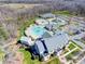 Expansive aerial view showcasing a community pool, water park, clubhouse, and surrounding green spaces at 5030 Lily Pond Cir, Waxhaw, NC 28173