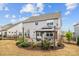 Well-maintained backyard with multiple patio areas, lush landscaping, and privacy fencing at 5030 Lily Pond Cir, Waxhaw, NC 28173